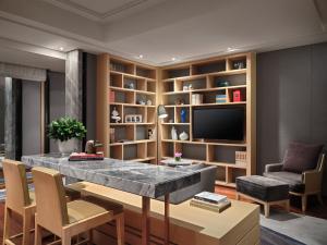 a living room filled with furniture and a tv at New World Beijing Hotel in Beijing