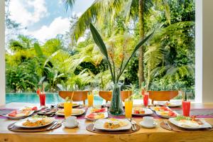 a table with plates of food on top of it at Villa Atas Awan in Payangan