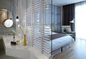 a bedroom with a bed and a glass wall at Marpessa Hotel & Spa in Agrinion