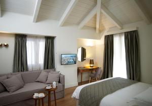 a hotel room with a bed and a couch at Marpessa Hotel & Spa in Agrinion