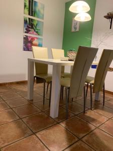 a dining room table with chairs and a white table at Apartments Banovci in Banovci