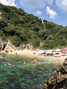 a group of people in the water at a beach at Villa Milka in Utjeha