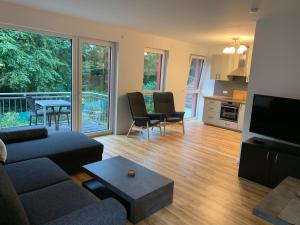 a living room with a couch and a table at Sonnige Apartments mit Terrasse in Essen