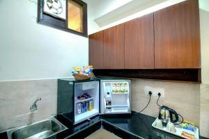 a small kitchen with a small refrigerator in it at STAAYZ Premium Gurgaon in Gurgaon