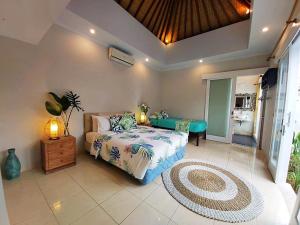 a bedroom with a bed and a table at Mudha Sindu Sanur 2 Bedrooms in Sanur