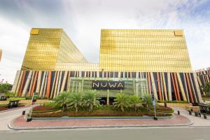 a building with a nku sign in front of it at City Of Dreams - Nüwa Manila in Manila