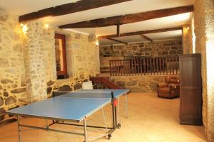 a ping pong table in a room with stone walls at Casa de José in Cabeceiras de Basto