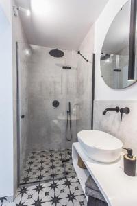a white bathroom with a shower and a sink at Chatka w trawach in Krakow +23 photos