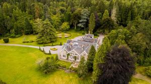 an aerial view of a large house in the woods at Scatwell House in Garve