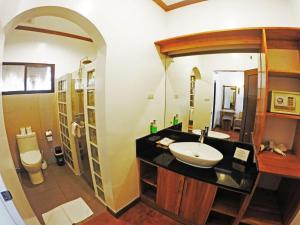 a bathroom with a sink and a toilet at Pura Vida Beach & Dive Resort in Dauin