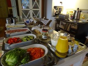 a kitchen counter with several trays of food on it at B&B Savikon Kartano in Kitee