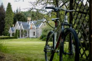 a bike parked in front of a house at Scatwell House in Garve