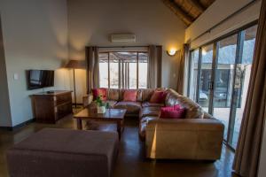 a living room with a couch and a table at Igugu Lodge in Hoedspruit