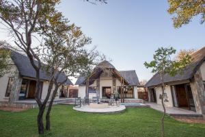 a person standing in the yard of a house at Igugu Lodge in Hoedspruit