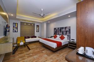 a hotel room with a bed and a couch at Hotel Nitya Maharani in New Delhi