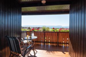 a patio with a table and chairs on a balcony at Apartment & Room Pristov in Žirovnica +14 photos