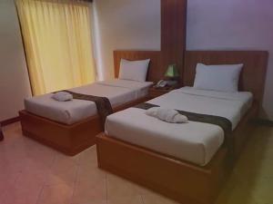 โรงแรมพิมายบุรี Phimaiburi Apartment客房内的一张或多张床位