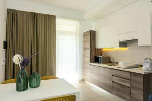 a kitchen with a table with a vase of flowers on it at BeeApartments in Bari