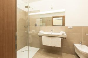 a bathroom with a sink and a shower at Hotel Appartement Inge in Tirolo