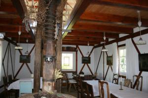 a dining room with tables and chairs and wooden ceilings at Weingut Albert, Familie Cramer in Kitzeck im Sausal
