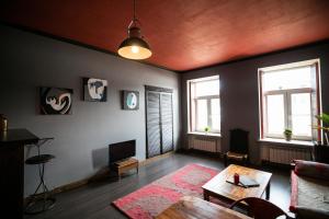 a living room with a couch and a table at A Boutique Apartments in Saint Petersburg