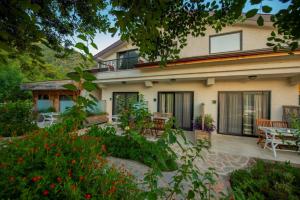a house with a patio and a table and chairs at S3 Seahorse Beach Club in Oludeniz