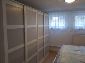 ein Schlafzimmer mit weißen Schränken und einem Bett darin in der Unterkunft Ferienwohnungen Seebad Ahlbeck in Ahlbeck