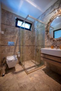 a bathroom with a shower and a toilet and a sink at S3 Seahorse Beach Club in Oludeniz