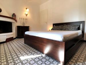 a bedroom with a large bed and a fireplace at La Terrazza di Re Scarlino in Scarlino