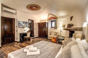 a living room with a bed and a fireplace at Boutique Relais Barozzi & SPA in Rome