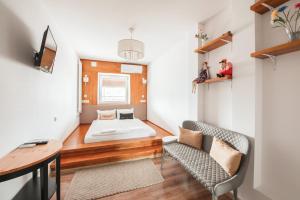 a living room with a bed and a couch at Ginger ApartHostel in Kraków