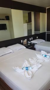 a hotel room with two beds with towels on them at Victory Flat Intermares n 64 ap 406 - Avenida Oceano Índico 64 -Intermares Cabedelo PB in Cabedelo +18 photos