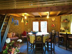 a kitchen and dining room with a table and chairs at Casa Nativo - The Heart of the Vineyard in Valle de Guadalupe