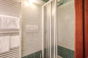 a shower with a glass door in a bathroom at Casa Carra in Rome