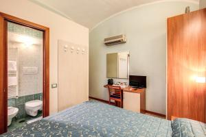 a hotel room with a bed and a bathroom at Casa Carra in Rome