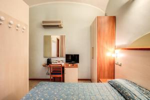 a hotel room with a bed and a desk at Casa Carra in Rome