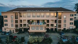 a large building with a sign that reads shawaho woodlands at Sarova Woodlands Hotel and Spa in Nakuru
