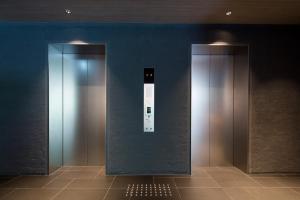 an elevator with a sign on the side of a wall at Shizutetsu Hotel Prezio Kyoto Shijo in Kyoto