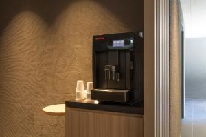 a hotel room with a coffee machine on a counter at Shizutetsu Hotel Prezio Kyoto Shijo in Kyoto