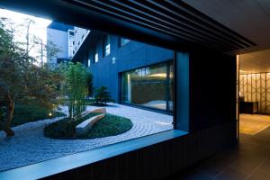 a view of a garden from a window of a building at Shizutetsu Hotel Prezio Kyoto Shijo in Kyoto