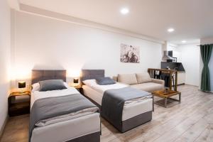 a living room with two beds and a couch at Penzión Imperial in Žarnovica