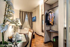 a living room with a table and a room with a couch at Boutique Relais Barozzi & SPA in Rome