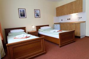 Postel nebo postele na pokoji v ubytování Hotel KAMU GARNI