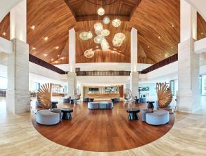 
a living room filled with furniture and a large window at Pullman Danang Beach Resort in Danang
