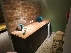 a kitchen with a counter and a brick wall at Svitiaz Griada in Szack +128 photos