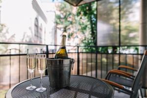 a bottle of wine in a bucket on a table with two glasses at Nordian Classic in Kyiv in Kyiv