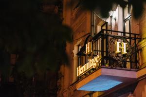 a sign on the side of a building at night at Hermitage Boutique-Hotel in Kyiv