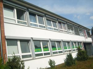a large white building with many windows at Hotel Wandsbek Hamburg in Hamburg