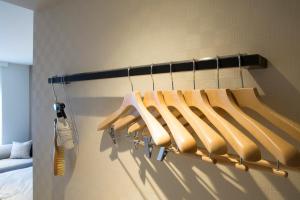 a rack of wooden hangers in a room at Shizutetsu Hotel Prezio Kyoto Shijo in Kyoto