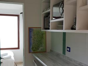 a bathroom with a sink and a map on the wall at Tiny Apartment Las Puyas Ocean View in Boca Pupuya